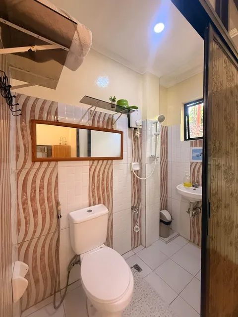 Private bathroom with a shower and water heater