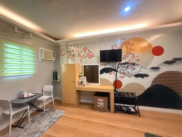 Room with a hand-painted mural, a desk and air-conditioning