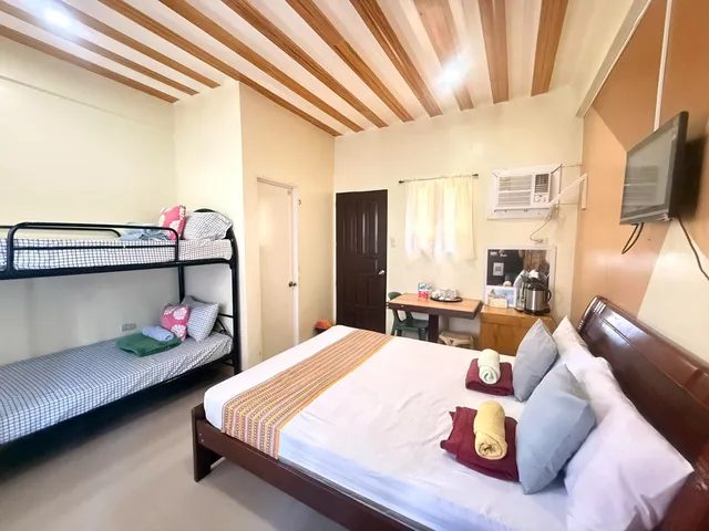 Room with a double bed and a bunk bed