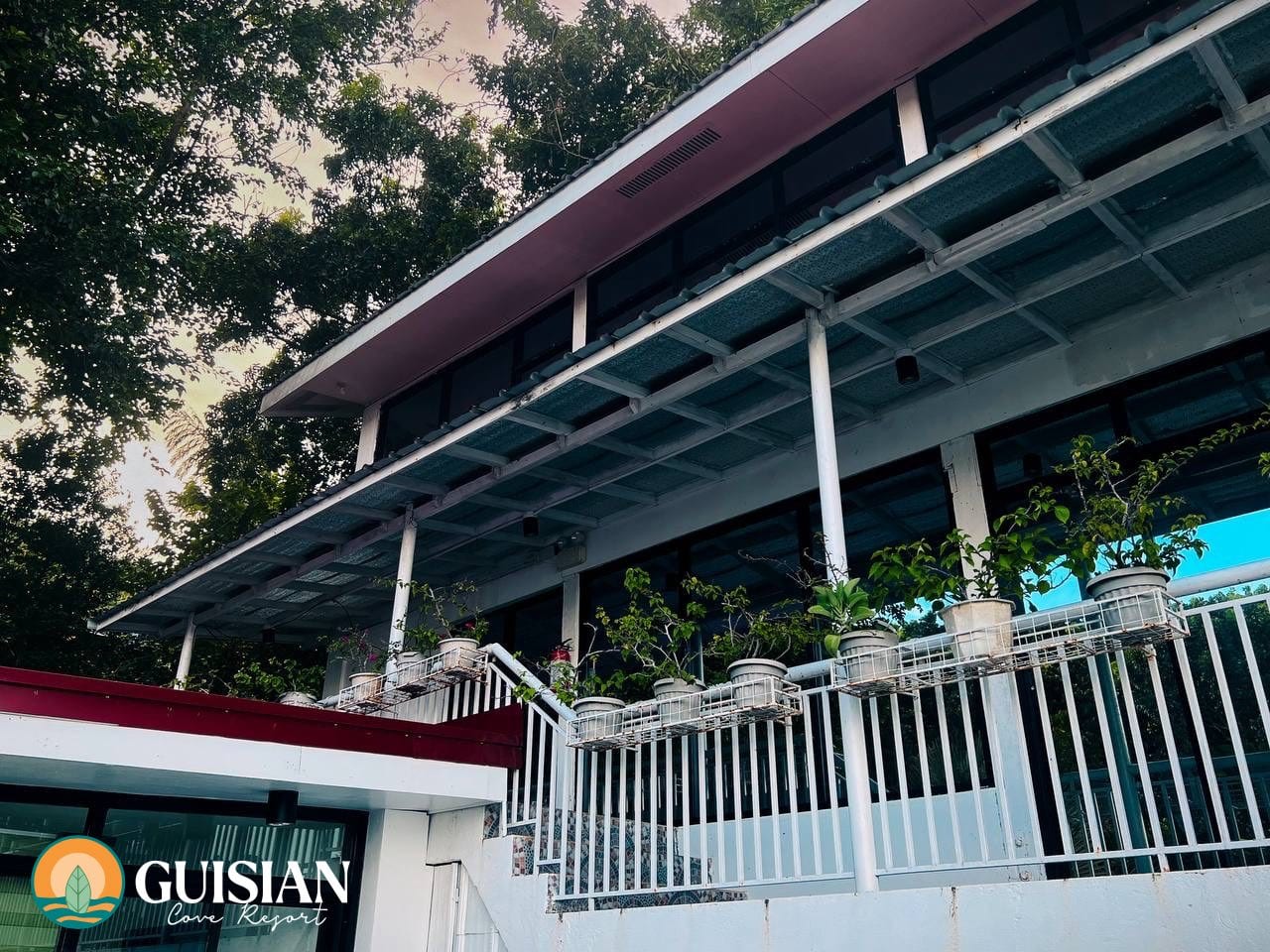 Plant-lined porch overhang and pitched roofline at Guisian Cove Resort